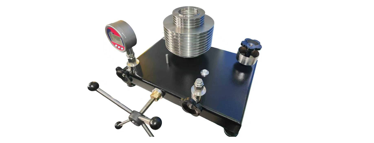 GPS LTD DWT series dead weight tester with the weight stack loaded and a gauge under test